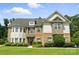 Charming two-story home with a well-manicured lawn, attractive brickwork, and decorative shutters at 16229 Loch Raven Rd, Huntersville, NC 28078