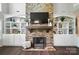 Stone fireplace with hearth and built-in shelving at 16229 Loch Raven Rd, Huntersville, NC 28078