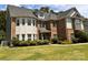 Charming brick and stone home featuring mature landscaping on a well-manicured lawn at 16229 Loch Raven Rd, Huntersville, NC 28078