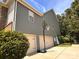 Three car garage with basketball hoop and gray vinyl siding at 16229 Loch Raven Rd, Huntersville, NC 28078