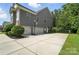 Spacious three-car garage with an extended driveway and basketball hoop, perfect for Gathering fun at 16229 Loch Raven Rd, Huntersville, NC 28078