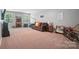 Cozy living room with sofa, shelving, decor, and natural light from the window at 16229 Loch Raven Rd, Huntersville, NC 28078