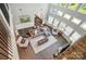 Bright, open living room with high ceilings, large windows, hardwood floors, and stylish decor at 16229 Loch Raven Rd, Huntersville, NC 28078