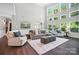 Open living room with a wall of windows and modern furnishings at 16229 Loch Raven Rd, Huntersville, NC 28078