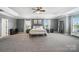 Expansive main bedroom suite with tray ceiling, sitting area, and neutral tones at 16229 Loch Raven Rd, Huntersville, NC 28078