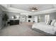 Spacious main bedroom featuring neutral tones, tray ceilings, a fireplace, and plenty of natural light at 16229 Loch Raven Rd, Huntersville, NC 28078