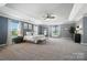 Large main bedroom boasting a tray ceiling, sitting area, and large windows with natural light at 16229 Loch Raven Rd, Huntersville, NC 28078