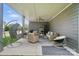 Outdoor covered patio features a hanging chair and comfortable wicker seating with a ceiling fan at 16229 Loch Raven Rd, Huntersville, NC 28078