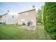 View of backyard featuring a sliding glass door to a small patio and lush lawn at 16525 Kettlewell Ln, Charlotte, NC 28277
