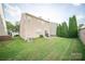 Backyard featuring a patio, lawn, and mature trees at 16525 Kettlewell Ln, Charlotte, NC 28277