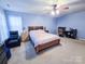 Bedroom with a ceiling fan and an adjacent office setup at 16525 Kettlewell Ln, Charlotte, NC 28277