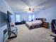 Spacious bedroom with a ceiling fan and plush carpet at 16525 Kettlewell Ln, Charlotte, NC 28277