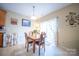 Inviting dining area featuring a wood table, four chairs, and a sliding glass door at 16525 Kettlewell Ln, Charlotte, NC 28277