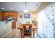 Bright dining area with wood table and chairs, adjacent to the kitchen area with natural light at 16525 Kettlewell Ln, Charlotte, NC 28277
