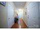 Inviting hallway with hardwood floors, white doors, and neutral walls creating a welcoming atmosphere at 16525 Kettlewell Ln, Charlotte, NC 28277