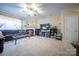 Spacious living room with carpet, a large sectional sofa, fireplace, and TV area at 16525 Kettlewell Ln, Charlotte, NC 28277