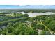 Expansive aerial view featuring lush trees, lake, a community pool, and beautiful neighborhood at 1720 Mountain Park Dr, Charlotte, NC 28214