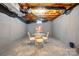 Unfinished basement with a table and chairs set, offering potential for customization and extra living space at 1720 Mountain Park Dr, Charlotte, NC 28214