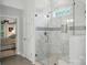 A luxury bathroom shower with marble tile and glass door adjacent to a soaking tub at 1720 Mountain Park Dr, Charlotte, NC 28214