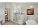 A well-lit bathroom showcases a glass shower and a soaking tub at 1720 Mountain Park Dr, Charlotte, NC 28214
