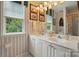 Bright bathroom features double sink vanity, framed lighthouse art, and a window offering pleasant natural light at 1720 Mountain Park Dr, Charlotte, NC 28214