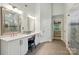 The bathroom has double sinks, a glass shower, and connects to the Primary bedroom at 1720 Mountain Park Dr, Charlotte, NC 28214