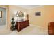 Bedroom showcasing wood dresser with butterfly decor and accent lamps against neutral colored walls and plush carpeting at 1720 Mountain Park Dr, Charlotte, NC 28214