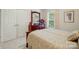 Cozy bedroom featuring a wood-framed bed, dresser with mirror, and closet for ample storage at 1720 Mountain Park Dr, Charlotte, NC 28214