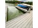 View of a covered boat on a lift at the dock, situated on the water at 1720 Mountain Park Dr, Charlotte, NC 28214