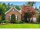Charming two-story brick home with a well-manicured lawn and mature trees, offering classic curb appeal at 1720 Mountain Park Dr, Charlotte, NC 28214