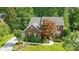 Charming two-story brick home featuring a well-manicured lawn and mature trees at 1720 Mountain Park Dr, Charlotte, NC 28214