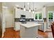 White kitchen with stainless steel appliances and a center island at 1720 Mountain Park Dr, Charlotte, NC 28214