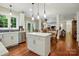 Bright kitchen featuring an island, stainless steel appliances, and an open view to the dining and living areas at 1720 Mountain Park Dr, Charlotte, NC 28214