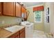 Functional laundry room with plenty of cabinet space, a sink, and a washing machine at 1720 Mountain Park Dr, Charlotte, NC 28214