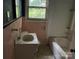 Shows a bathroom with pink tile, sink, and a bathtub at 1769 S Nc 16 Hwy, Denver, NC 28037