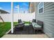 Private backyard patio featuring comfortable seating area, string lights, and green space at 2013 Eastway Dr, Dallas, NC 28034