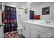 Fun bathroom featuring a shower with a colorful Marvel-themed curtain and double sink vanity at 2013 Eastway Dr, Dallas, NC 28034