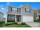 Charming two-story home with a well-maintained lawn, two-car garage, and welcoming front porch at 2013 Eastway Dr, Dallas, NC 28034