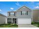 Two-story home with a gray exterior, a two-car garage, and a covered front porch area at 2013 Eastway Dr, Dallas, NC 28034
