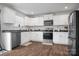 Modern kitchen featuring white cabinets, stainless steel appliances, and hardwood floors at 2013 Eastway Dr, Dallas, NC 28034