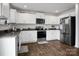Modern kitchen featuring stainless steel appliances, granite countertops, and white cabinetry at 2013 Eastway Dr, Dallas, NC 28034