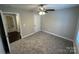 Cozy bedroom with neutral carpet, a ceiling fan, and a view of the hallway at 203 Bennett St, Wadesboro, NC 28170