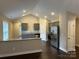 Open-concept kitchen with stainless steel appliances, granite countertops, and ample cabinet space at 203 Bennett St, Wadesboro, NC 28170