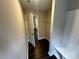 Bright hallway with wood floors that leads past the hall closet and features a built-in bench at 207 Bennett St, Wadesboro, NC 28170