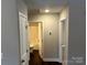 Hallway view of the bathroom with a tub and the bedroom with carpet at 207 Bennett St, Wadesboro, NC 28170