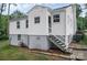 Exterior view of the rear of home featuring a stairway access to a fully fenced backyard at 2108 Twin Ave, Gastonia, NC 28052