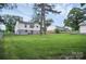 Large, lush backyard view showing the rear exterior of the home at 2108 Twin Ave, Gastonia, NC 28052