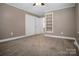 This bedroom has a closet, an open shelving area, neutral paint, and white trim at 2108 Twin Ave, Gastonia, NC 28052