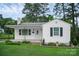 Charming home featuring a well-manicured lawn and a classic white exterior with decorative flower beds at 2108 Twin Ave, Gastonia, NC 28052