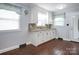 Functional kitchen with white cabinetry, attractive countertops, wood-look floors, and plenty of natural light at 2108 Twin Ave, Gastonia, NC 28052